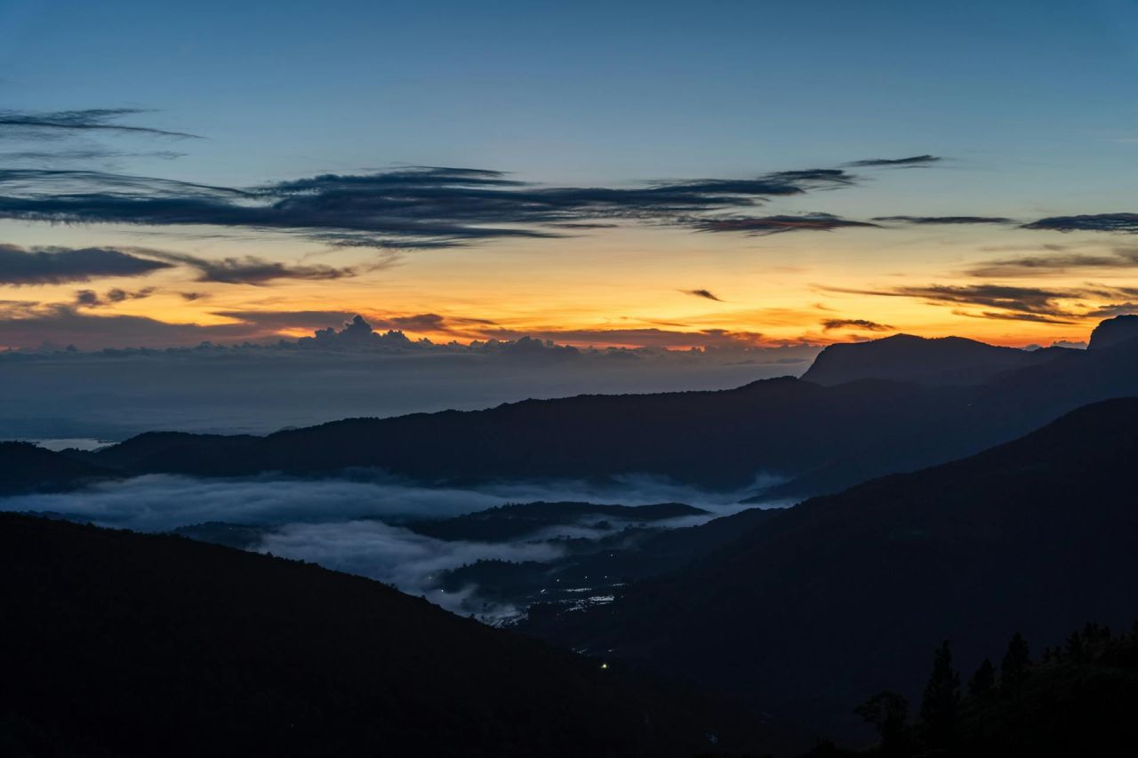 Mist in the valleys as dawn breaks over the peaks near Elle, Sri Lanka.